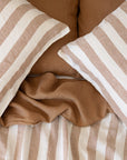 Hazelnut Stripe pillowcases with a Hazelnut and Stripe linen duvet cover underneath