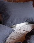 midnight blue linen bedding with a textured pattern on a bed.