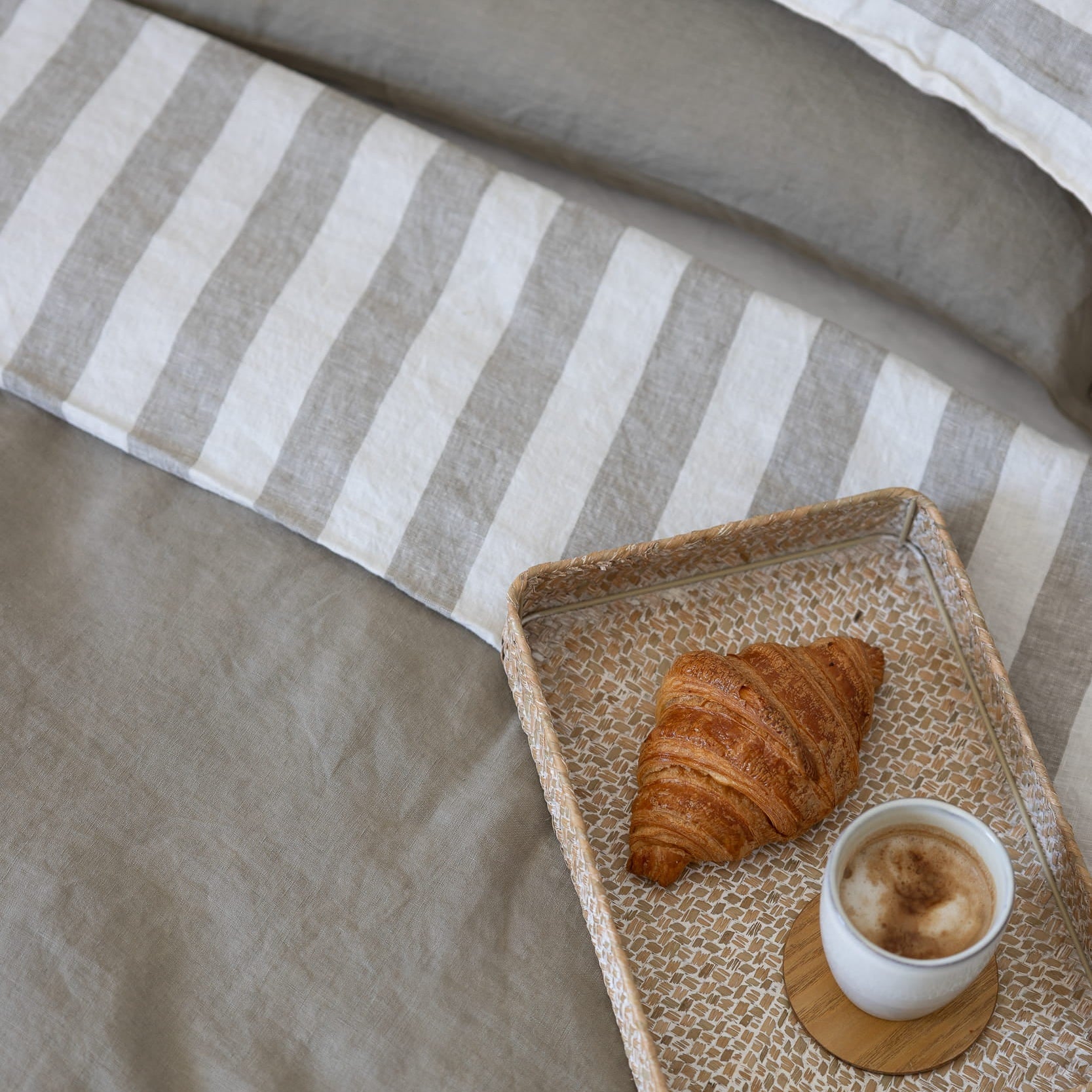 Tess and Tess Linen bedding, mossy green and ivory, croissant and coffee 