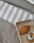 Tess and Tess Linen bedding, mossy green and ivory, croissant and coffee 