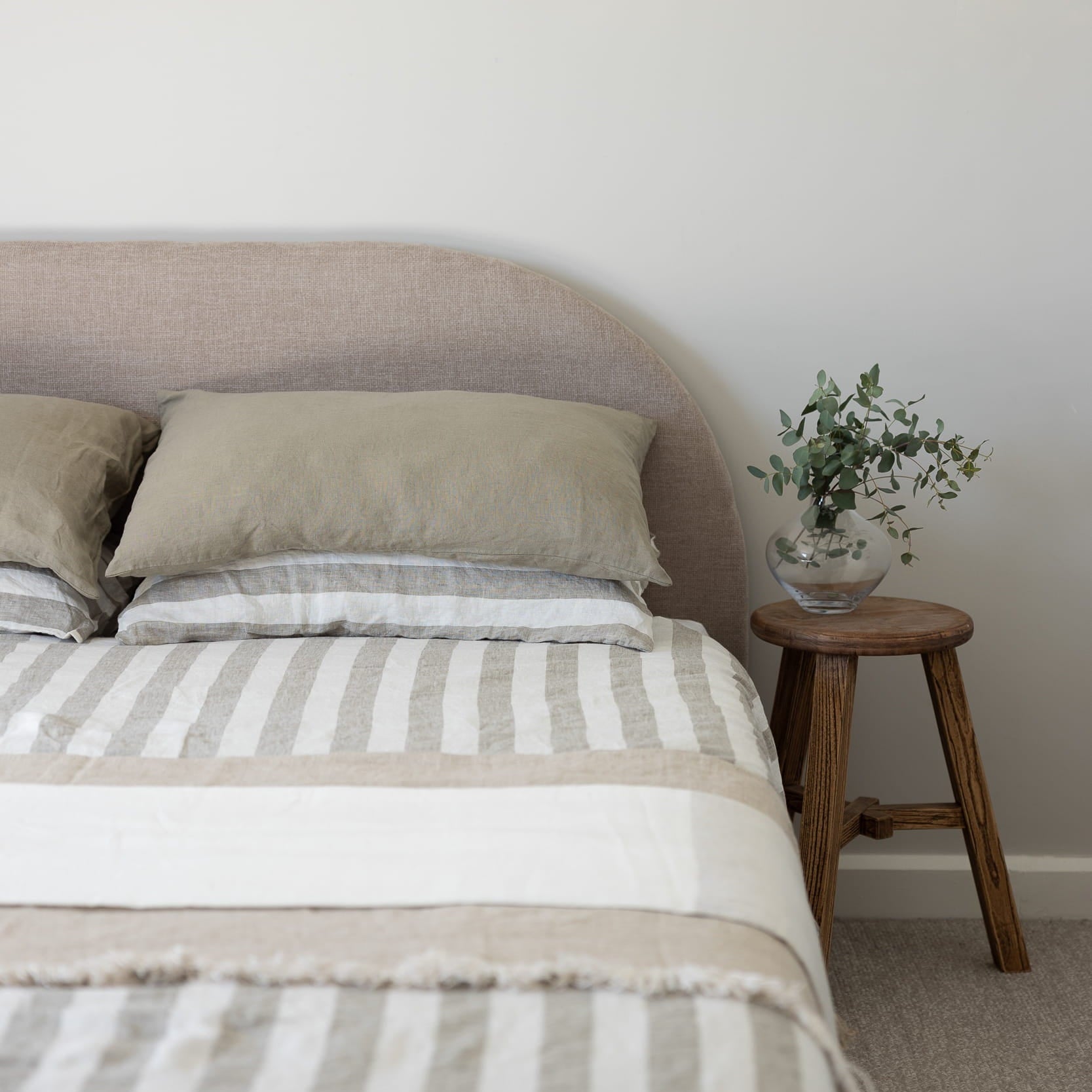 Tess Stripe linen bedding with tess pillowcases and a Cove linen throw and a dune linen throw. 